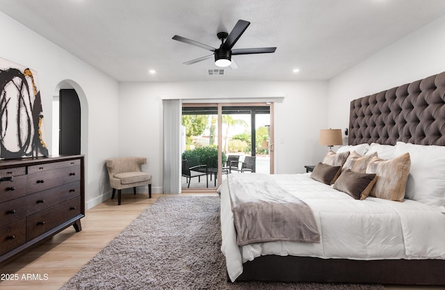bedroom featuring access to outside, light wood-style flooring, arched walkways, recessed lighting, and ceiling fan