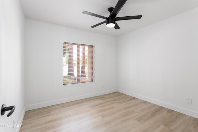 unfurnished room with wood finished floors, ceiling fan, and baseboards