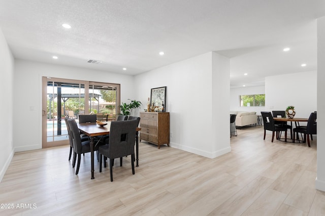 dining space with recessed lighting, light wood-style floors, and baseboards
