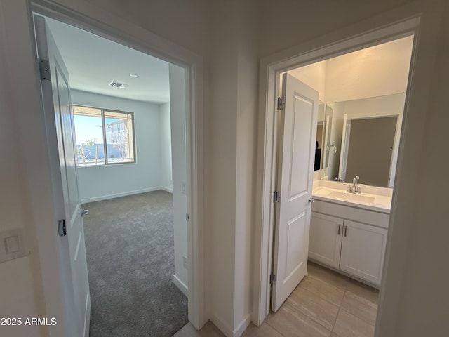 bathroom with visible vents, baseboards, and vanity