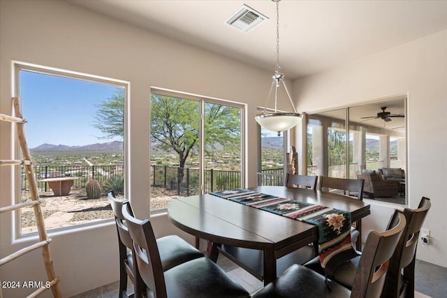 dining area featuring a mountain view and a healthy amount of sunlight