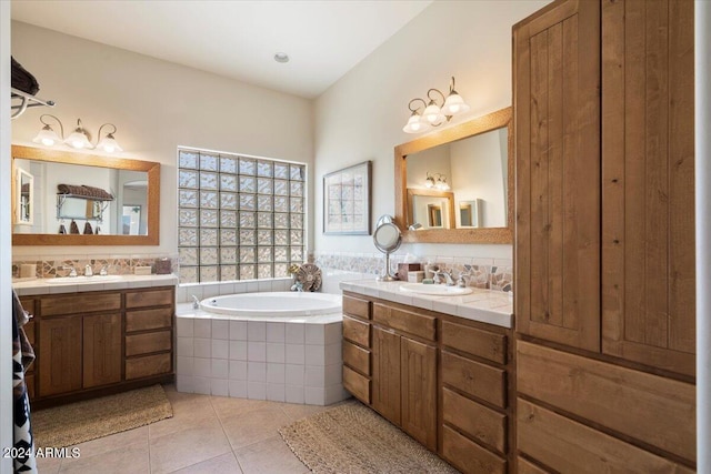 bathroom with vanity, tiled tub, and tile patterned floors