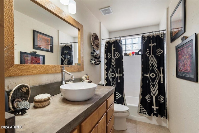 full bathroom with shower / tub combo with curtain, tile patterned floors, toilet, and vanity