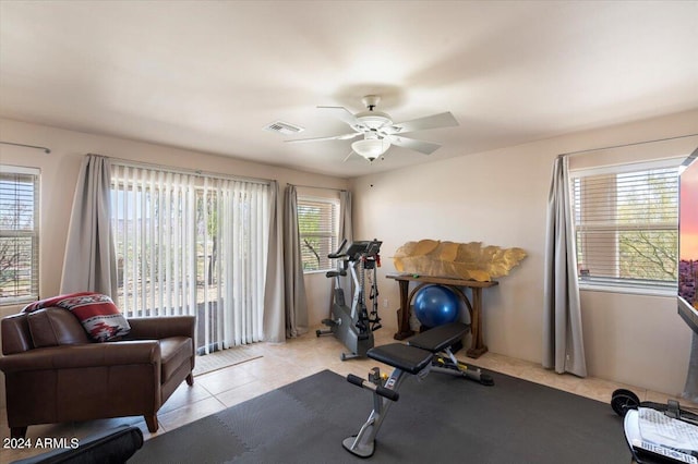 workout room featuring light tile patterned flooring and ceiling fan