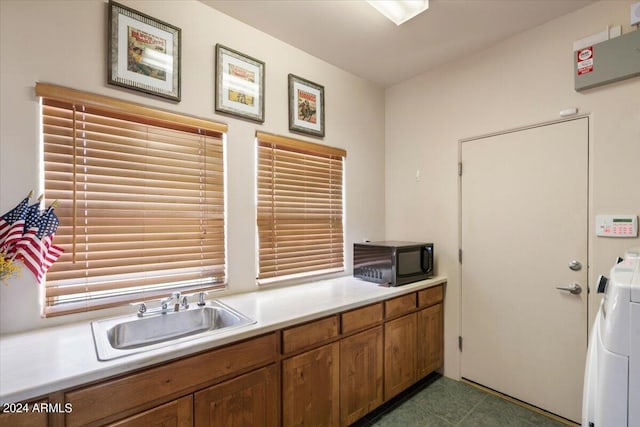 kitchen with washer / clothes dryer and sink