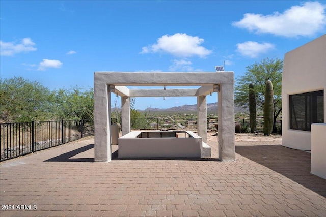 view of patio with a mountain view and a pergola