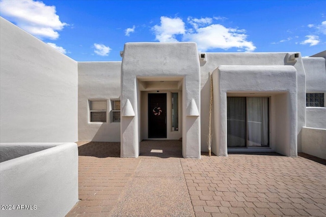 property entrance featuring a patio area