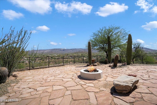 view of patio featuring a mountain view and a fire pit