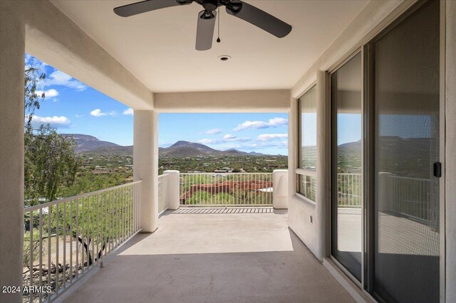 balcony with a mountain view and ceiling fan