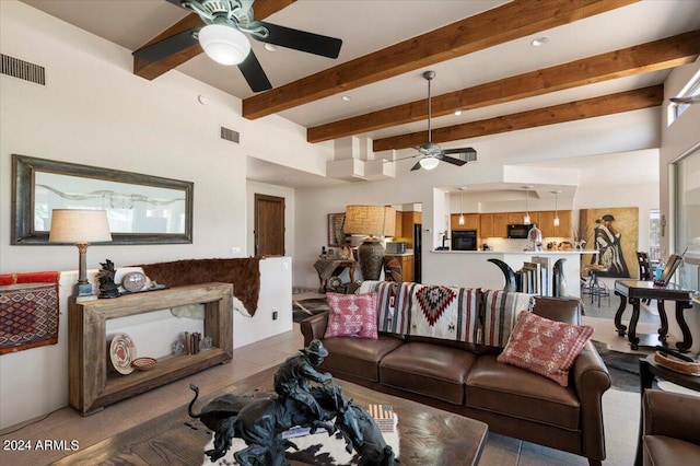 living room featuring beamed ceiling, tile patterned floors, and ceiling fan