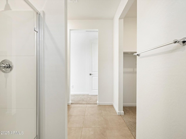 bathroom featuring a shower and tile patterned floors