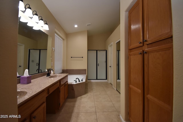 9145 W Menadota Dr, Peoria, AZ 85382 - full bath featuring a stall shower, tile patterned floors, a bath, visible vents, and a sink