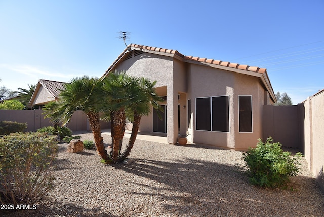 9145 W Menadota Dr, Peoria, AZ 85382 - back of house featuring a patio area, a fenced backyard, a tiled roof, and stucco siding