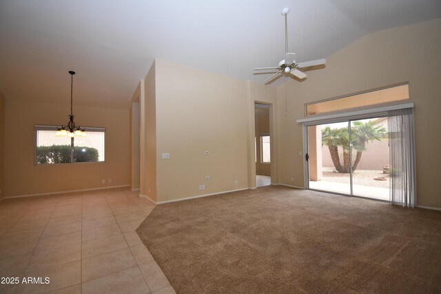 9145 W Menadota Dr, Peoria, AZ 85382 - unfurnished living room with a wealth of natural light, ceiling fan with notable chandelier, baseboards, and light tile patterned flooring