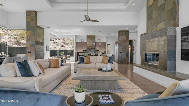1805 E Rocky Slope Dr, Phoenix, AZ 85048 - living area featuring recessed lighting, a tray ceiling, ceiling fan, and a fireplace
