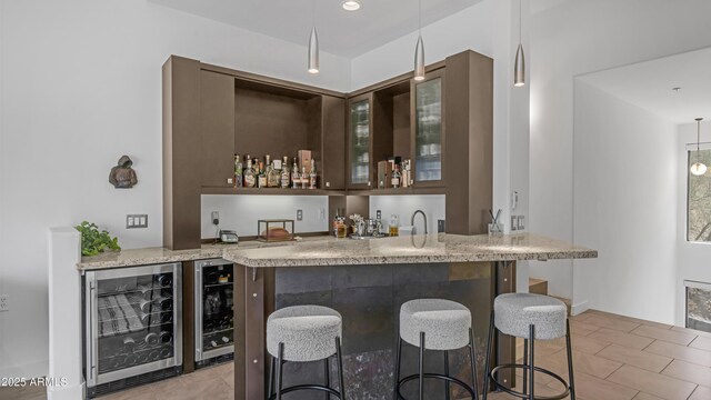 1805 E Rocky Slope Dr, Phoenix, AZ 85048 - bar with beverage cooler, light tile patterned floors, and indoor wet bar