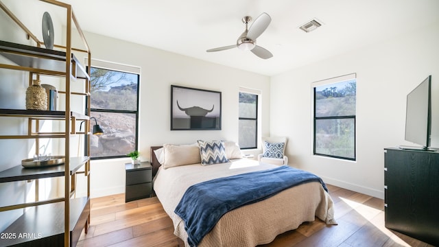 1805 E Rocky Slope Dr, Phoenix, AZ 85048 - bedroom featuring light wood-type flooring, baseboards, visible vents, and ceiling fan