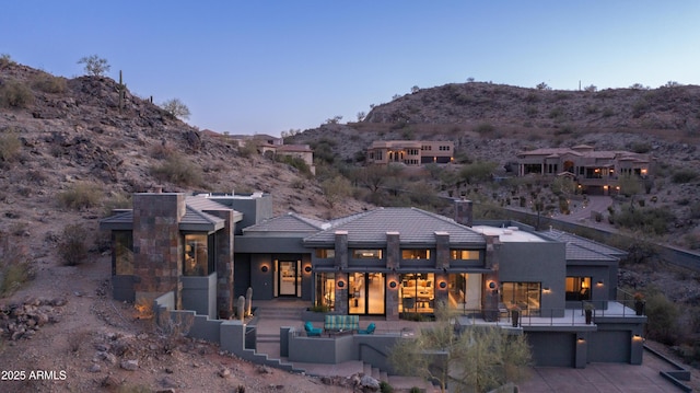 1805 E Rocky Slope Dr, Phoenix, AZ 85048 - rear view of property featuring a tiled roof, stucco siding, driveway, a garage, and a mountain view