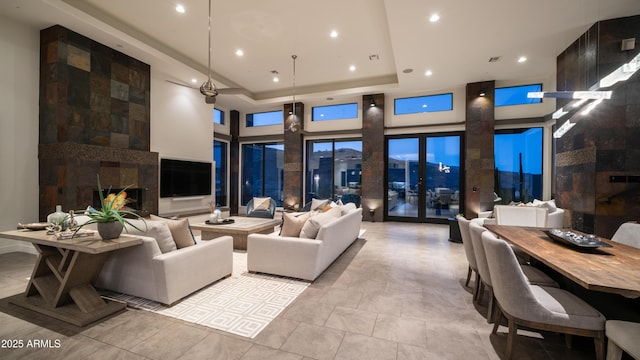 1805 E Rocky Slope Dr, Phoenix, AZ 85048 - living room featuring light tile patterned floors, recessed lighting, a high end fireplace, a towering ceiling, and a raised ceiling