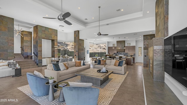 1805 E Rocky Slope Dr, Phoenix, AZ 85048 - living area with visible vents, a tray ceiling, a ceiling fan, and dark tile patterned flooring