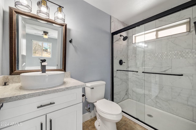 bathroom with vanity, tile patterned floors, ceiling fan, toilet, and a shower with shower door