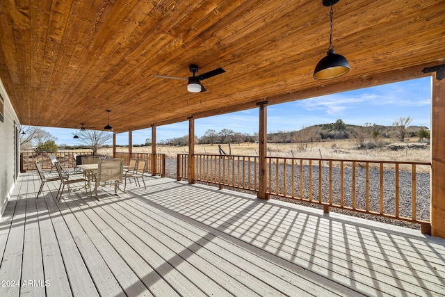 deck featuring ceiling fan and a rural view