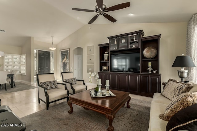 tiled living room featuring ceiling fan and vaulted ceiling