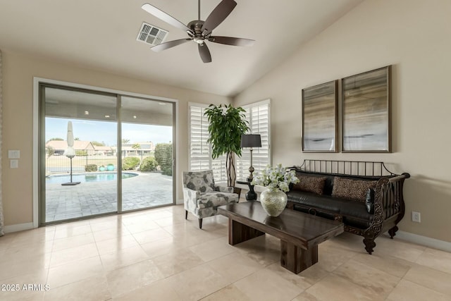 tiled living room featuring ceiling fan and vaulted ceiling