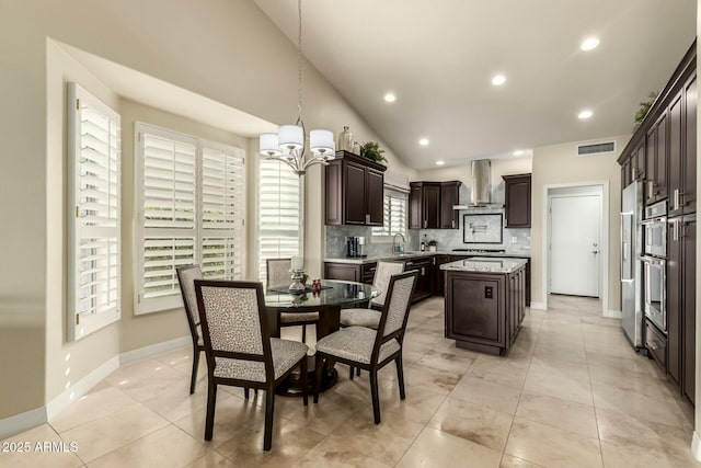 tiled dining area with lofted ceiling, an inviting chandelier, a wealth of natural light, and sink