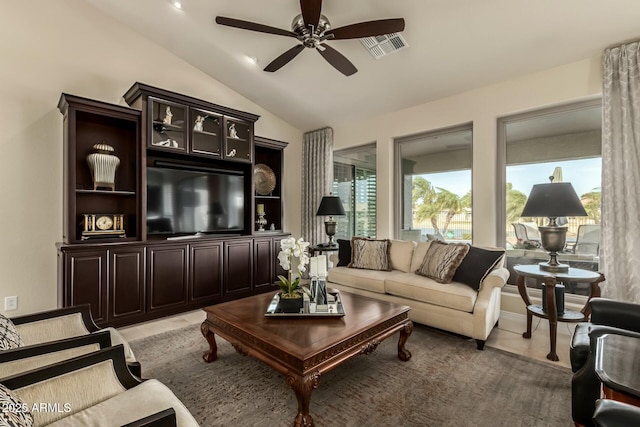 living room featuring ceiling fan and vaulted ceiling