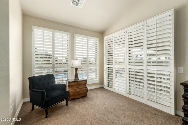 living area featuring carpet floors and lofted ceiling