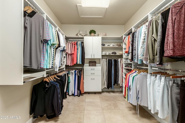 walk in closet featuring light tile patterned flooring