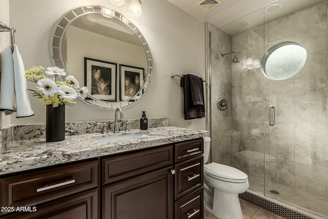 bathroom with toilet, an enclosed shower, tile patterned floors, and vanity