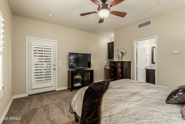 carpeted bedroom with ensuite bath and ceiling fan