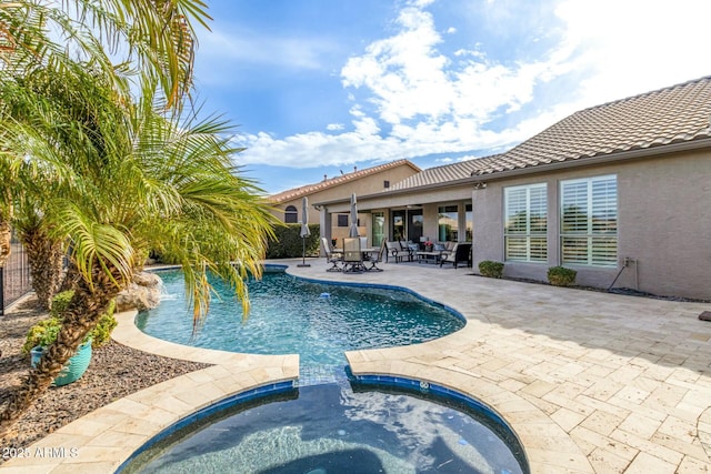 view of pool with an in ground hot tub and a patio