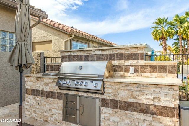 view of patio / terrace with area for grilling and a grill