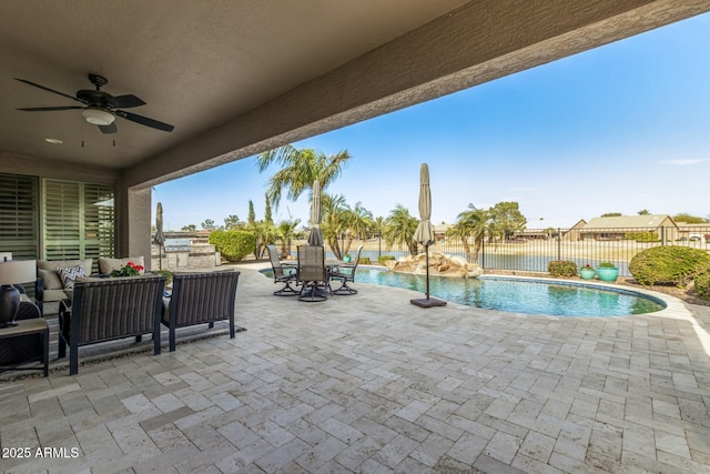 view of pool with ceiling fan and a patio area