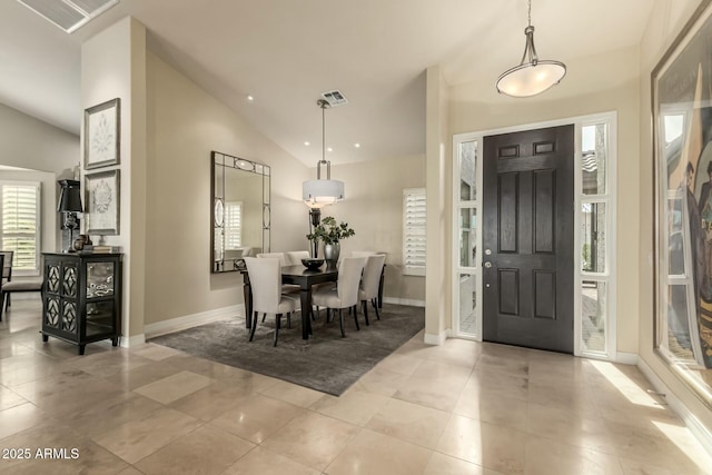 dining room featuring light tile patterned flooring and lofted ceiling