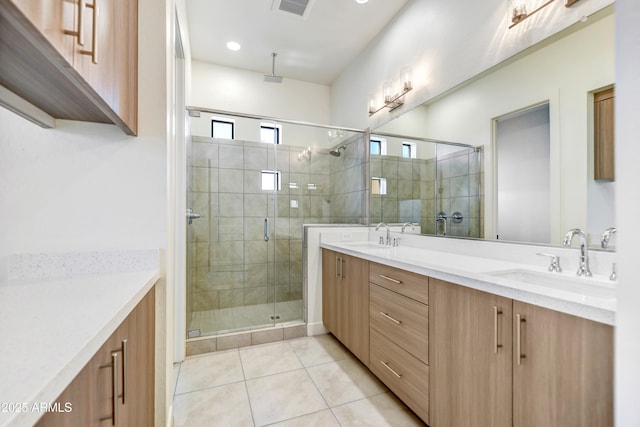 bathroom featuring tile patterned flooring, walk in shower, and vanity