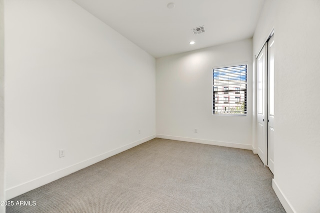 unfurnished room with light carpet