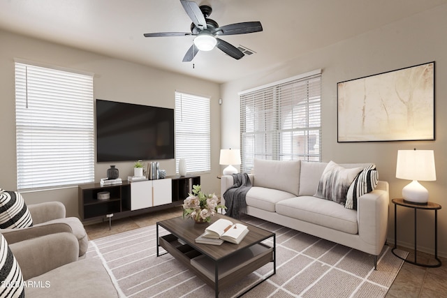 living room featuring ceiling fan and tile patterned floors