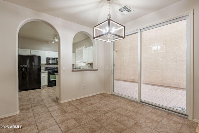 unfurnished dining area with a chandelier