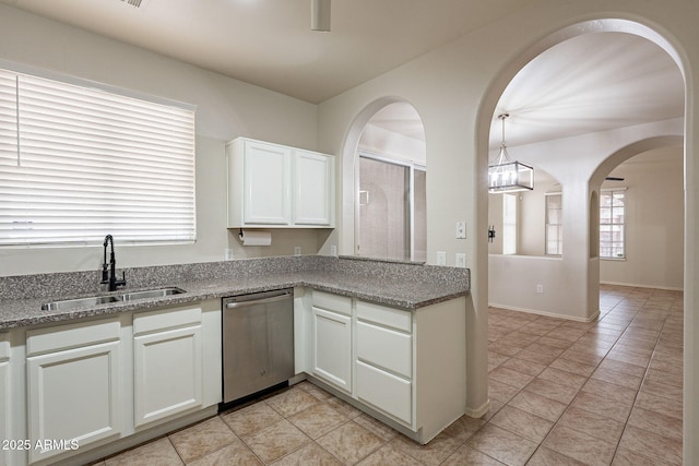 kitchen featuring white cabinetry, sink, light stone countertops, and dishwasher