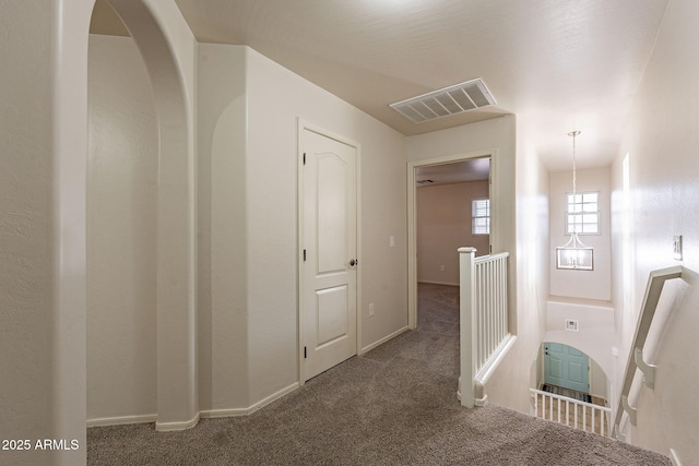 hallway featuring dark carpet