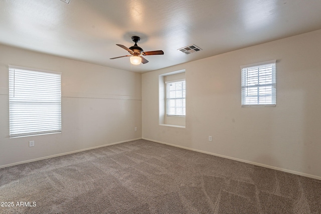 spare room with ceiling fan and carpet flooring