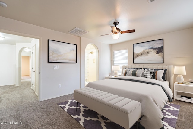 bedroom with ceiling fan, ensuite bathroom, and carpet