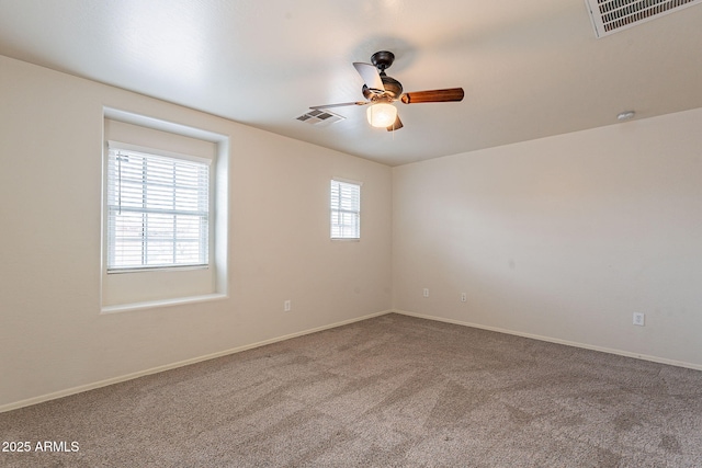 spare room featuring ceiling fan and carpet