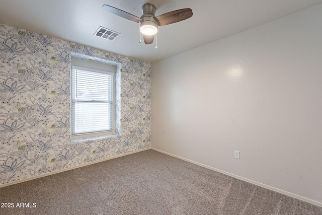 carpeted empty room featuring ceiling fan