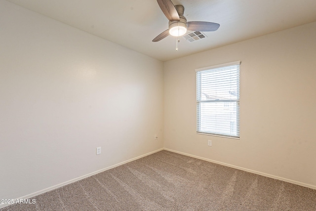 carpeted empty room featuring ceiling fan