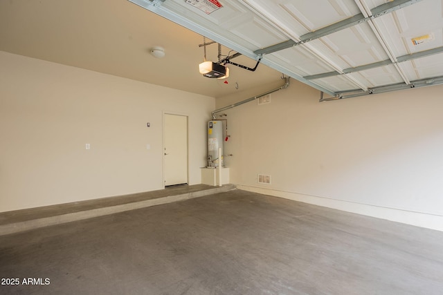 garage featuring a garage door opener and water heater